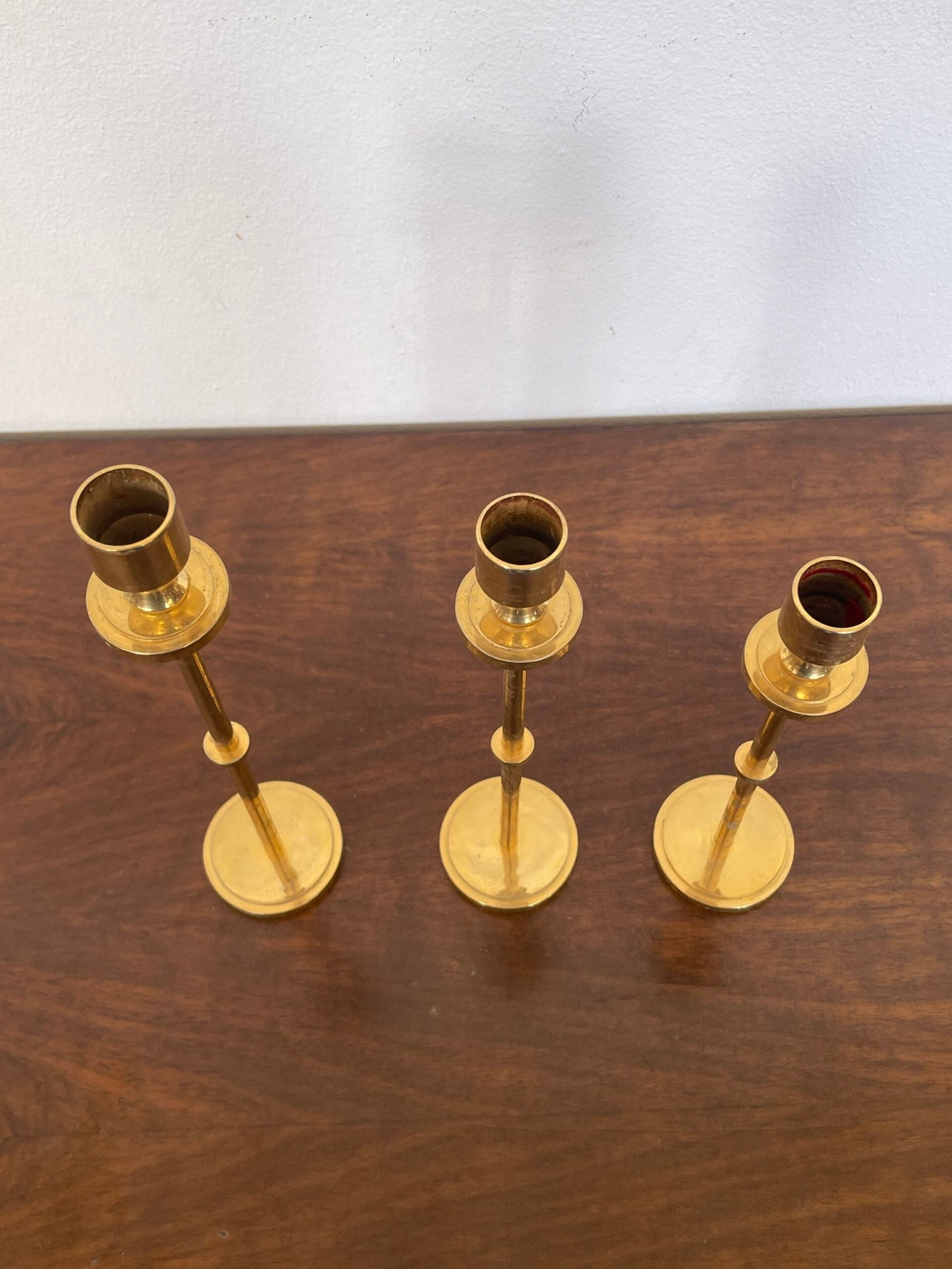 Tris di portacandele modernisti in ottone lucido, dal design minimalista ed elegante.