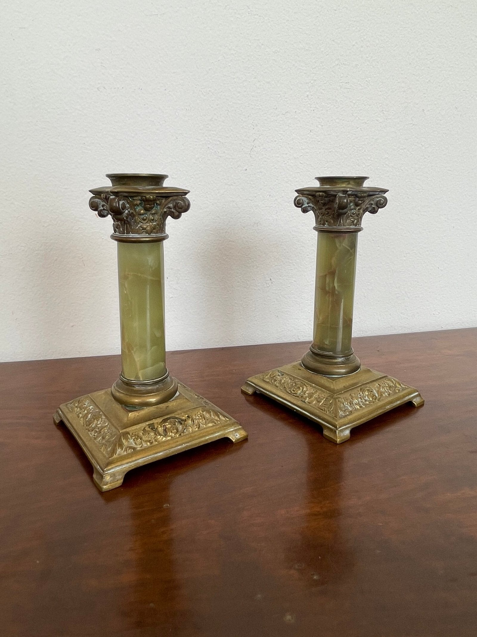 Elegante coppia di candelabri in stile neoclassico, con una base solida in bronzo dorato e colonne in marmo