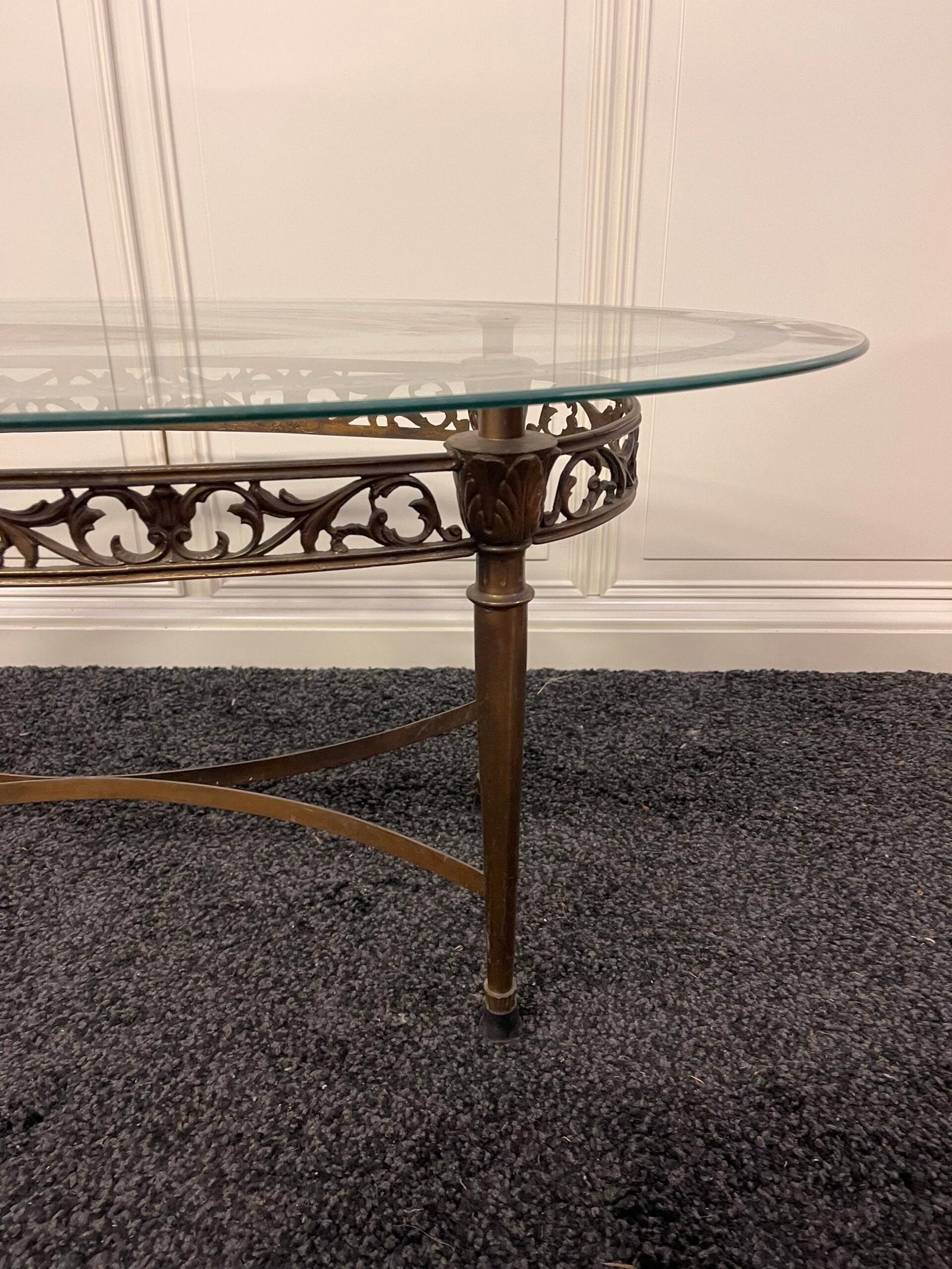 Tavolino da salotto ovale con piano in vetro e struttura in ferro battuto